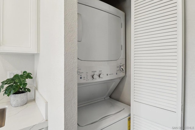 laundry area with stacked washer / drying machine