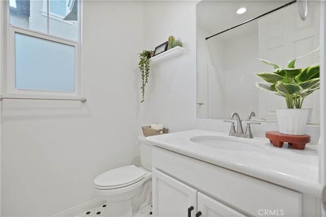 bathroom with toilet and vanity