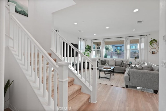 staircase featuring wood-type flooring