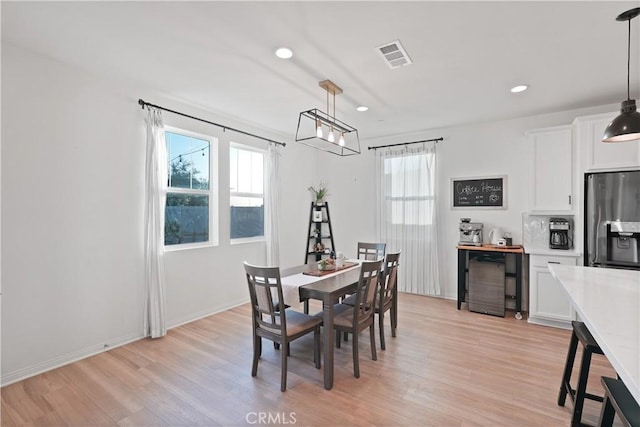 dining space featuring a wealth of natural light and light wood-type flooring