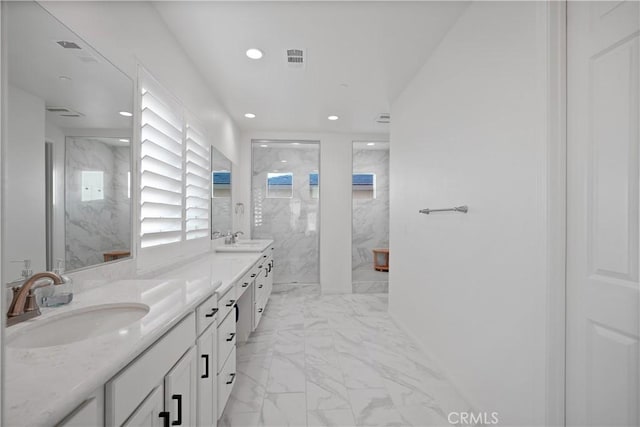 bathroom featuring walk in shower and vanity