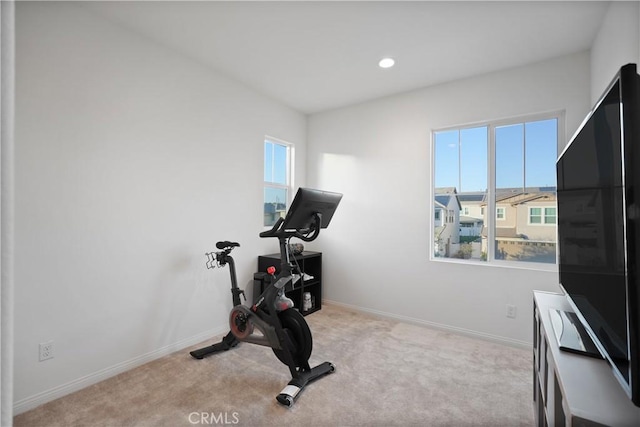 exercise room with light colored carpet