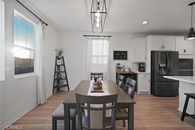 dining space with plenty of natural light and light wood-type flooring