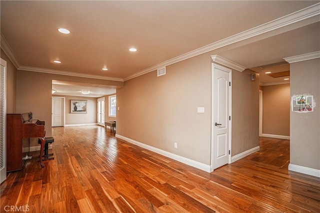 corridor featuring ornamental molding and wood-type flooring