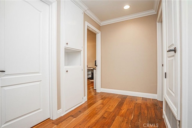 hallway featuring crown molding and hardwood / wood-style flooring