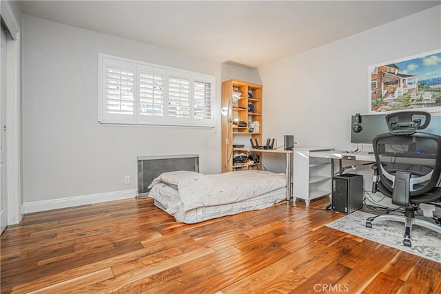 bedroom with hardwood / wood-style flooring