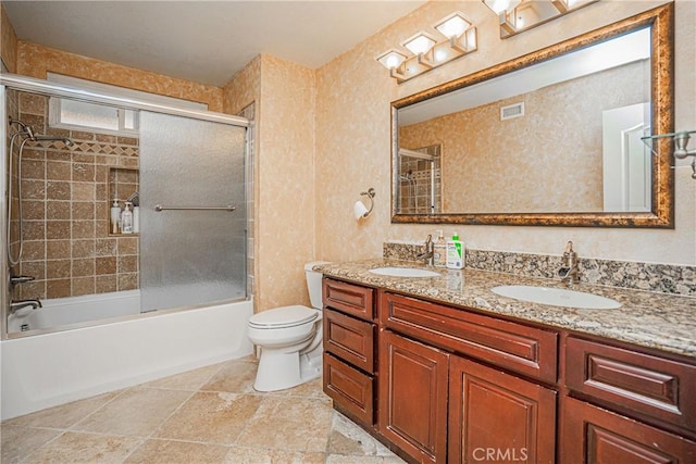 full bathroom featuring toilet, enclosed tub / shower combo, and vanity