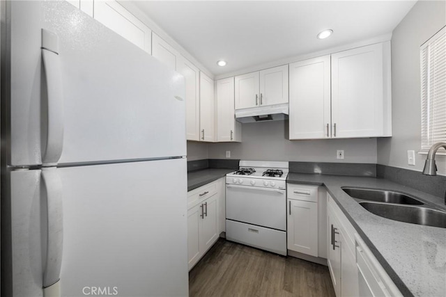 kitchen featuring white cabinets, dark hardwood / wood-style floors, sink, and white appliances