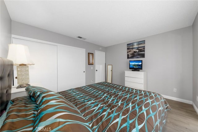 bedroom featuring a closet and hardwood / wood-style floors