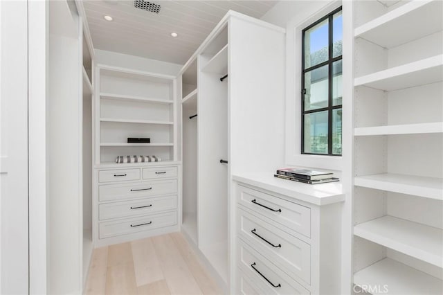 walk in closet with light wood-type flooring