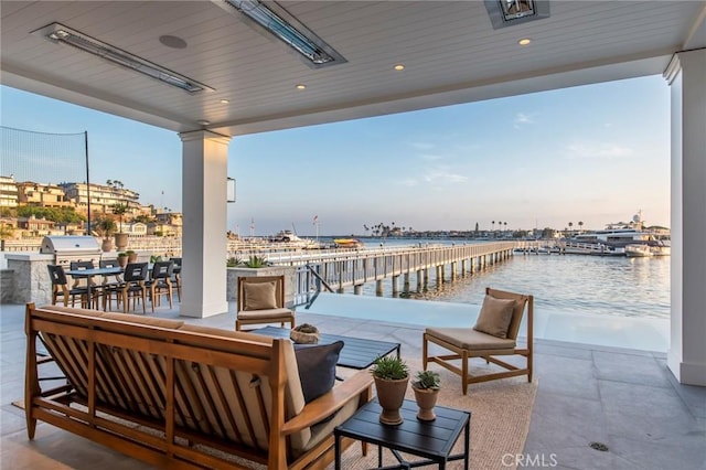 exterior space with a water view and outdoor lounge area