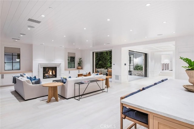 living room with a wall of windows and wood ceiling