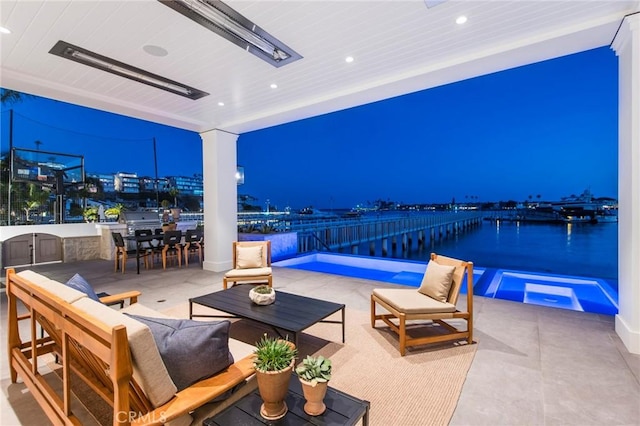 patio at twilight featuring an outdoor living space, a water view, and a pool with hot tub