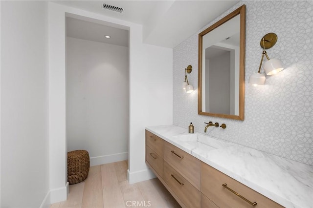 bathroom with hardwood / wood-style floors and vanity