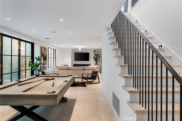 playroom with light hardwood / wood-style floors and billiards