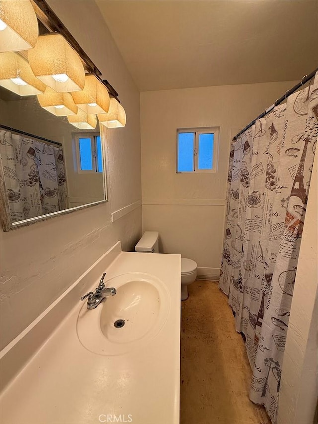 bathroom featuring toilet, sink, and concrete floors