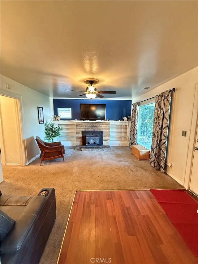 carpeted living room with ceiling fan