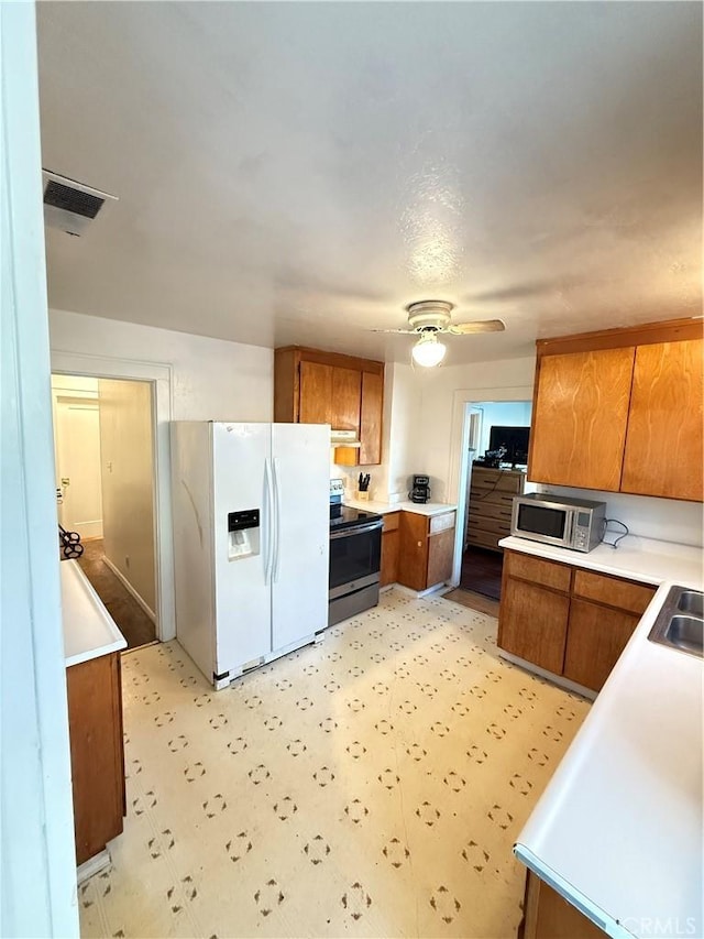 kitchen with sink, stainless steel appliances, and ceiling fan