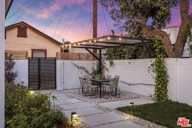 patio terrace at dusk with a pergola