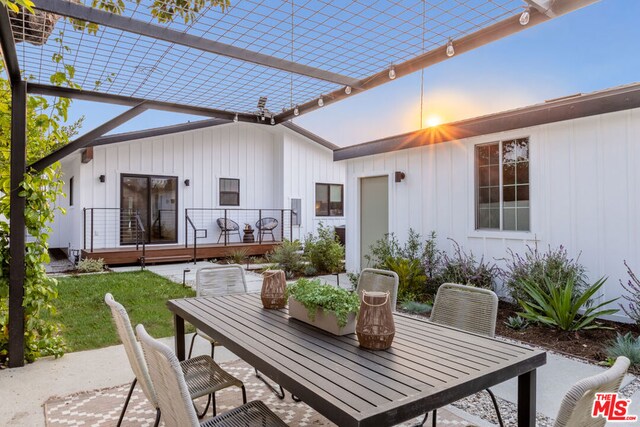 patio terrace at dusk featuring a deck