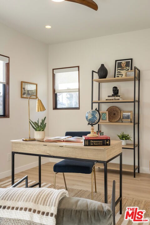 home office with light hardwood / wood-style flooring