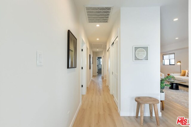 hallway with light hardwood / wood-style flooring