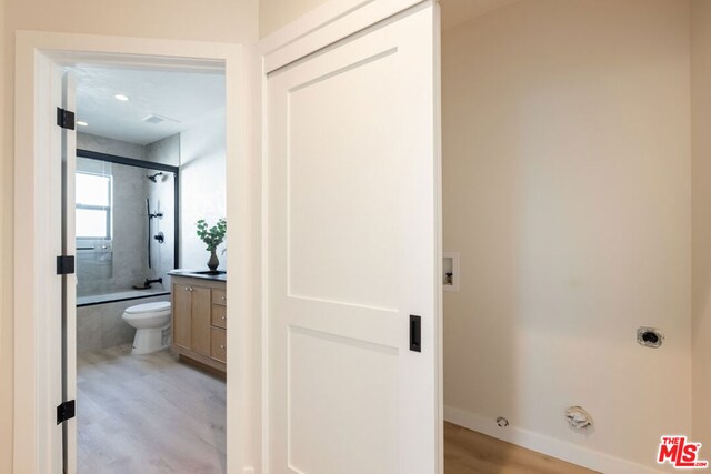 bathroom featuring hardwood / wood-style flooring, vanity, and toilet