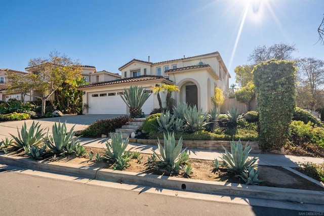 mediterranean / spanish-style home with a garage