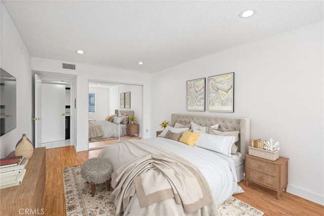 bedroom featuring a closet and light wood-type flooring