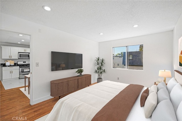 bedroom with a textured ceiling and hardwood / wood-style floors