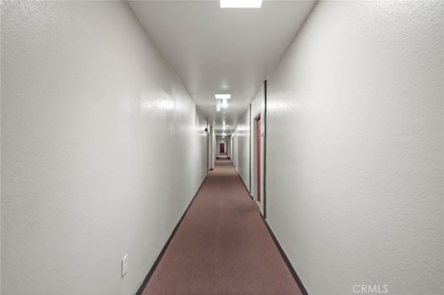 hallway featuring dark carpet