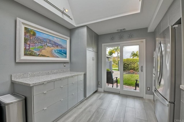 doorway to outside with lofted ceiling