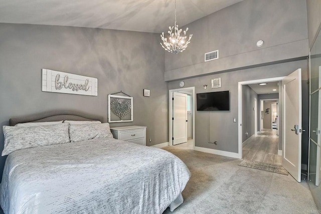 carpeted bedroom with a chandelier