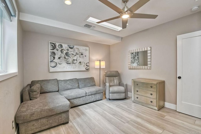 living room with ceiling fan and light hardwood / wood-style flooring