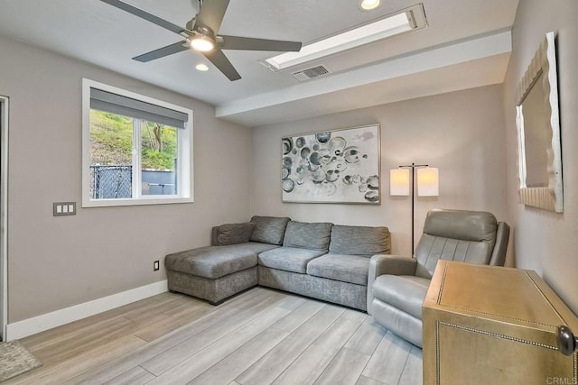 living room featuring ceiling fan and light hardwood / wood-style flooring