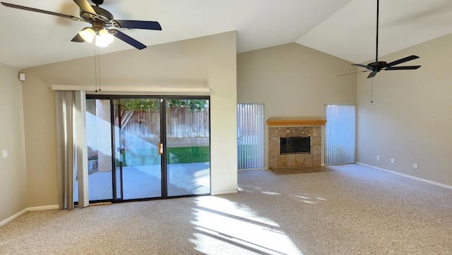 unfurnished living room with lofted ceiling, ceiling fan, a tile fireplace, and carpet flooring