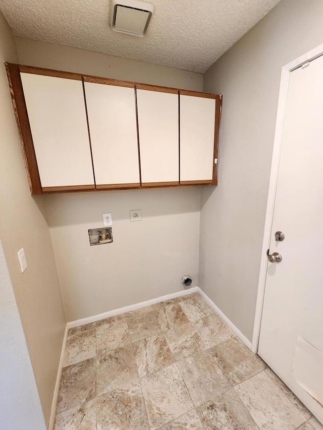 clothes washing area featuring a textured ceiling, cabinets, washer hookup, and hookup for an electric dryer