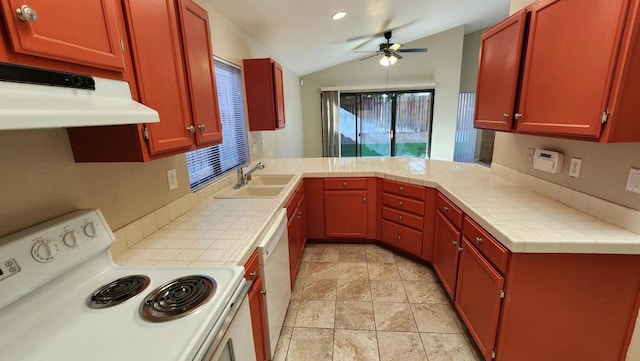 kitchen with tile countertops, kitchen peninsula, ceiling fan, white appliances, and sink