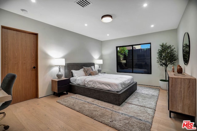 bedroom with light hardwood / wood-style floors