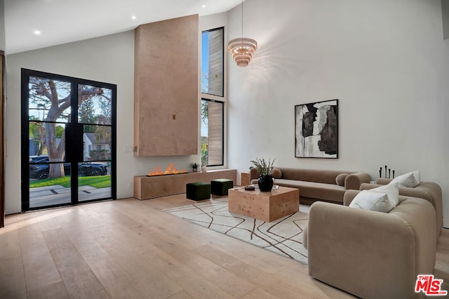 living room with lofted ceiling and light hardwood / wood-style floors