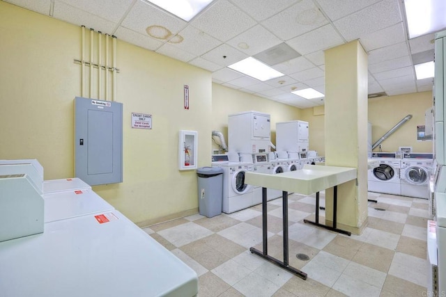 laundry area with washer and dryer, stacked washer and clothes dryer, and electric panel