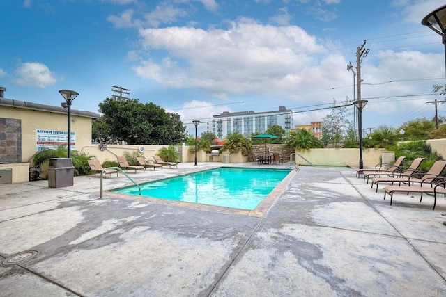 view of pool featuring a patio area and a bar