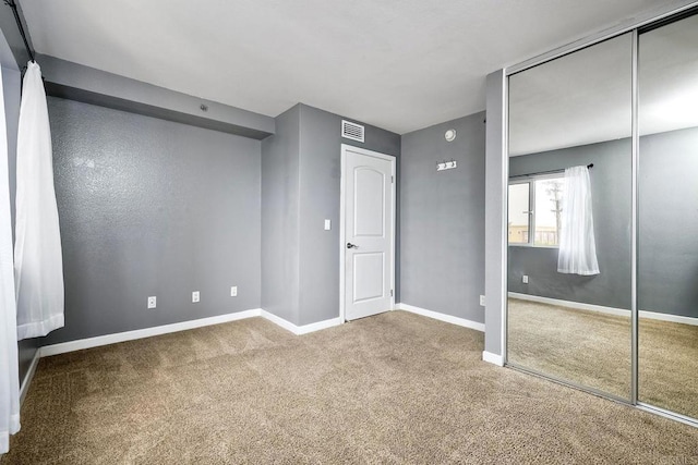 unfurnished bedroom with a closet and carpet