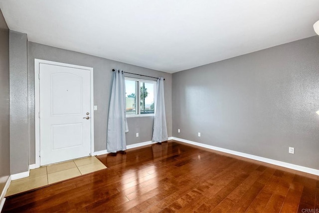 unfurnished room with wood-type flooring