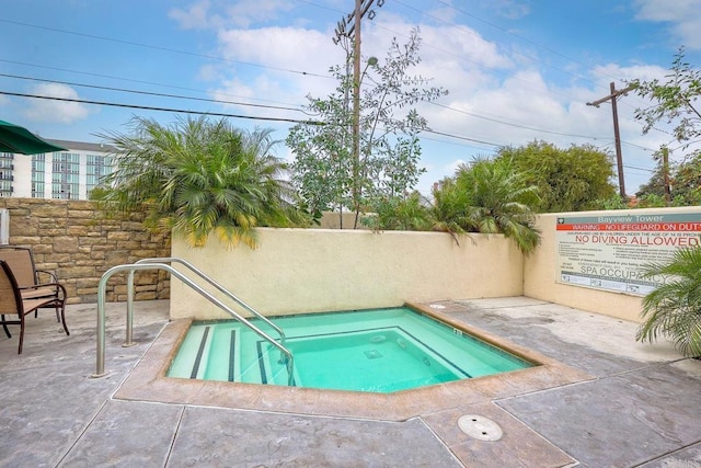 view of swimming pool with a community hot tub