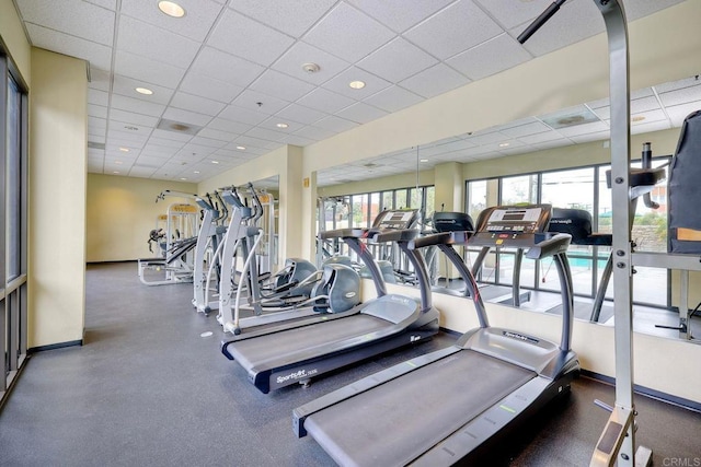 gym with a paneled ceiling