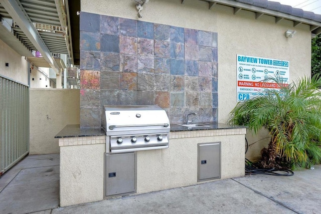 view of patio / terrace featuring grilling area, an outdoor kitchen, and sink