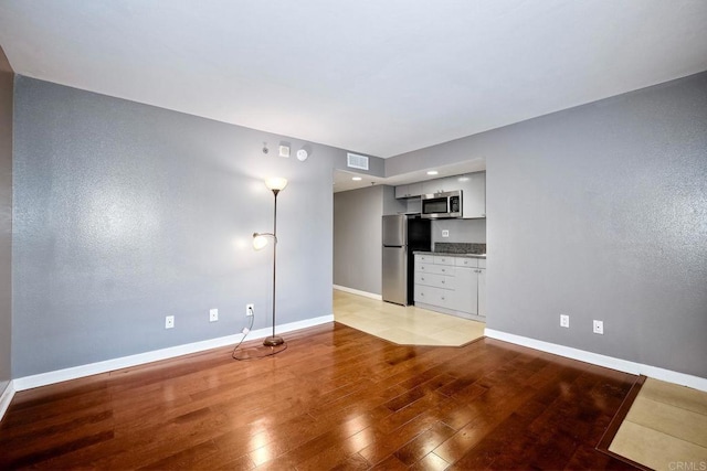 unfurnished living room featuring light hardwood / wood-style flooring