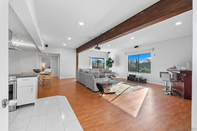 living room featuring beam ceiling and light hardwood / wood-style flooring