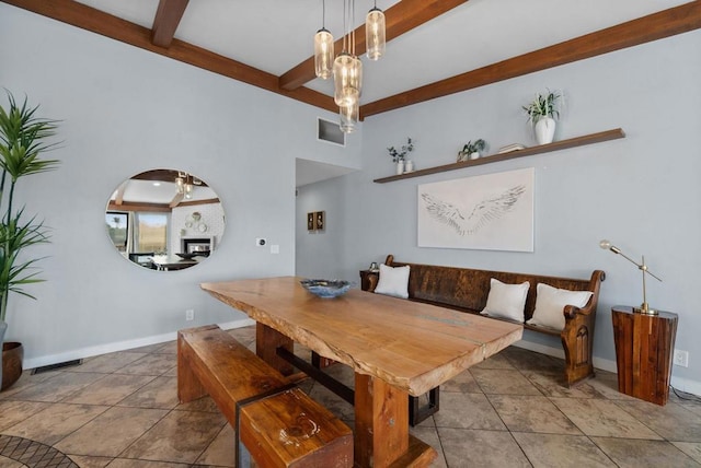 tiled dining room with breakfast area and beam ceiling